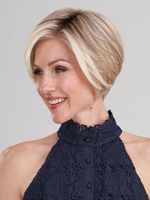 Model is wearing IGNITE by JON RENAU in color 101/88/27S8 CATALINA BLONDE | Pale blonde with Pure White Natural Violet halo highlights, shaded medium brown